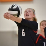 Girls Volleyball player hitting ball